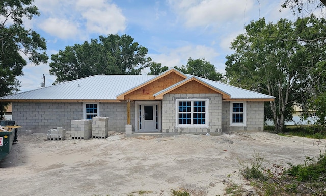 view of front facade featuring metal roof and concrete block siding