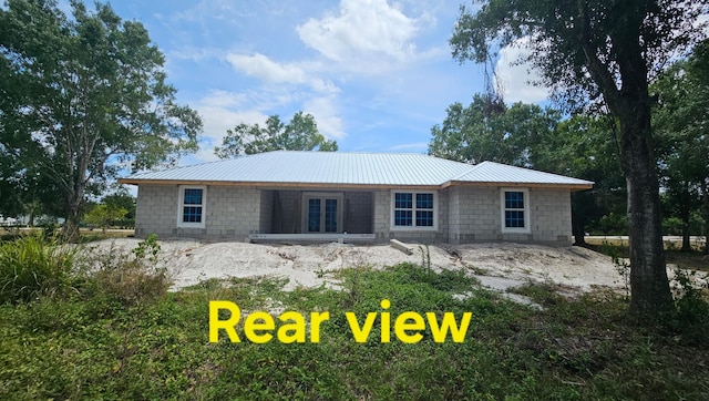 back of house with french doors and metal roof