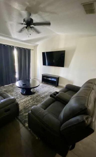 living room featuring visible vents and a ceiling fan