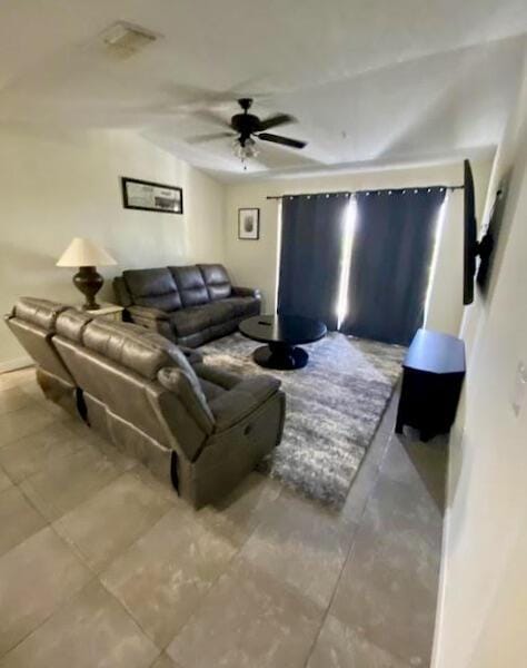 living area featuring visible vents and ceiling fan