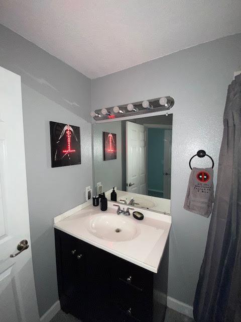 bathroom with vanity and baseboards