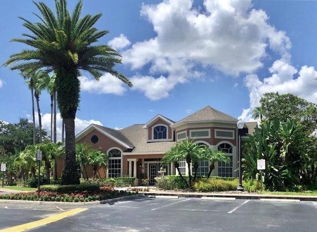 view of property featuring uncovered parking