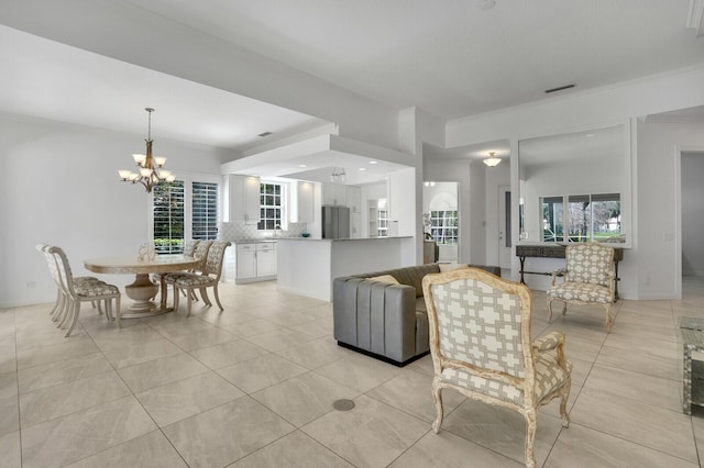 living room featuring plenty of natural light, light tile patterned flooring, and a notable chandelier