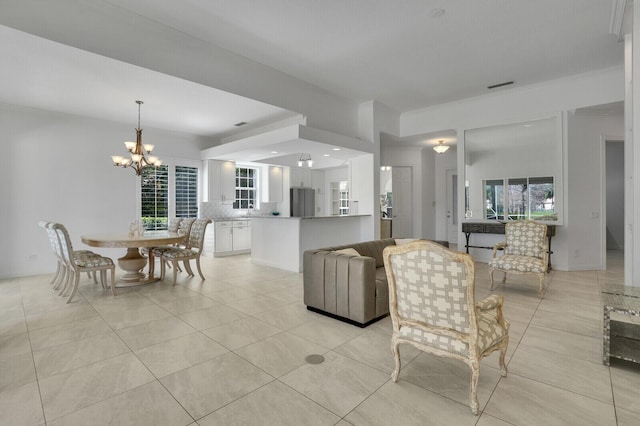 living room featuring a wealth of natural light, light tile patterned flooring, and an inviting chandelier