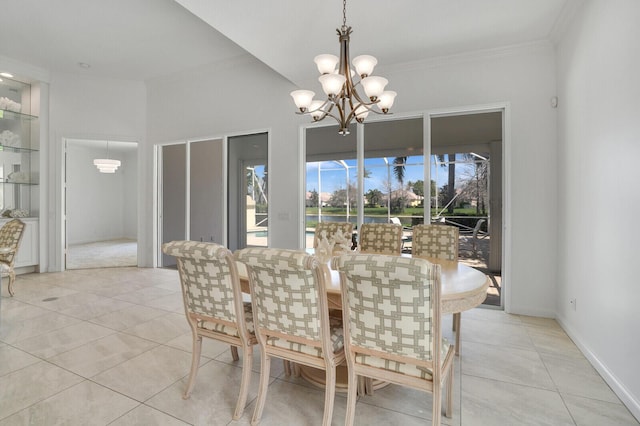 dining space featuring ornamental molding, light tile patterned flooring, baseboards, and an inviting chandelier