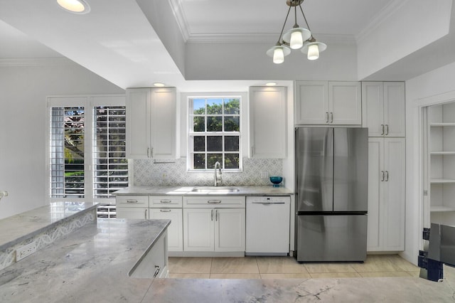 kitchen with a sink, freestanding refrigerator, dishwasher, decorative light fixtures, and crown molding