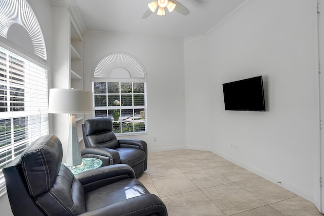 sitting room with light tile patterned floors, baseboards, a ceiling fan, ornamental molding, and built in shelves