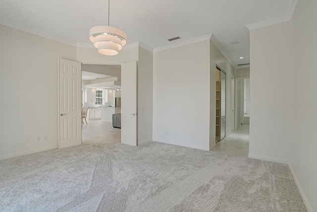 unfurnished room featuring visible vents, ornamental molding, baseboards, and light colored carpet