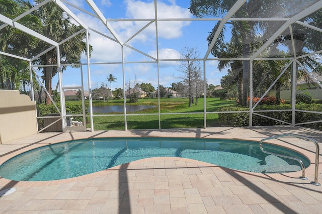 pool featuring a patio area, glass enclosure, and a water view