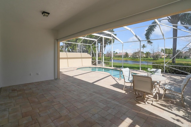 pool featuring a water view, glass enclosure, and a patio