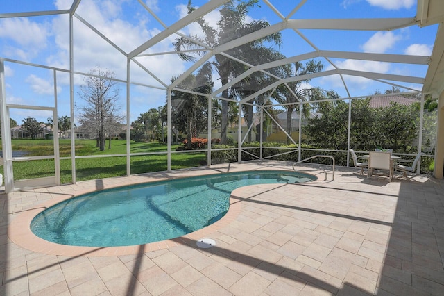 outdoor pool with a lawn, a patio area, and a lanai