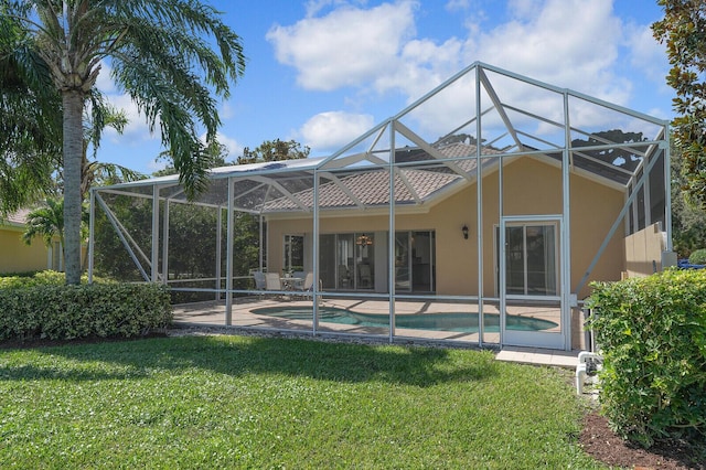 rear view of property featuring a patio, a lanai, a lawn, an outdoor pool, and stucco siding