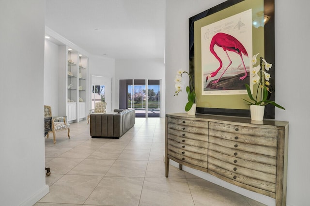 corridor featuring built in features and tile patterned floors