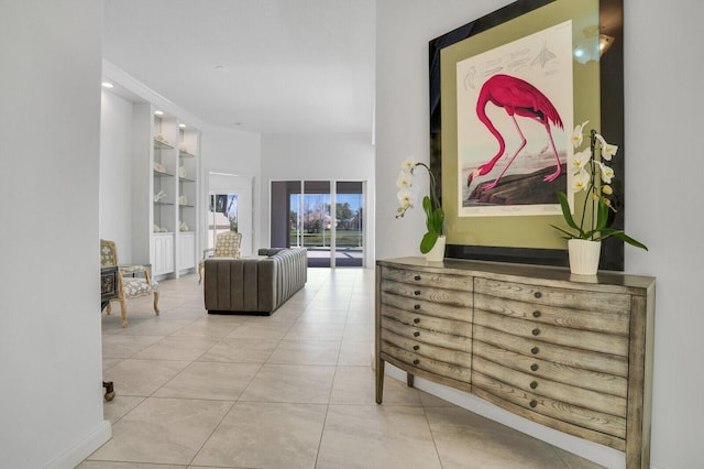 corridor featuring built in shelves and light tile patterned flooring