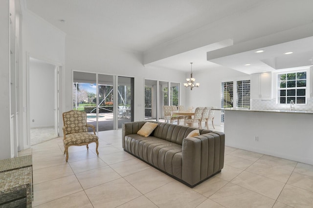 living area featuring light tile patterned floors, recessed lighting, and an inviting chandelier