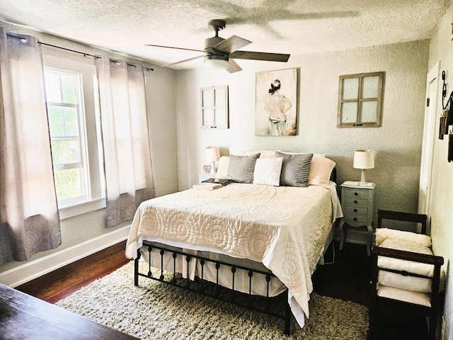 206 Edgewood Dr, West Palm Beach, FL 33405 - bedroom with baseboards, a textured ceiling, wood finished floors, and a textured wall