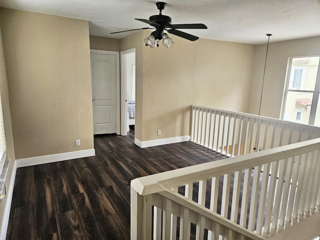 interior space with baseboards and wood finished floors