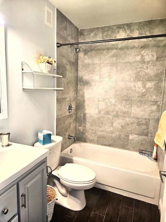 206 Edgewood Dr, West Palm Beach, FL 33405 - bathroom featuring visible vents, wood finish floors, toilet, shower / tub combination, and vanity
