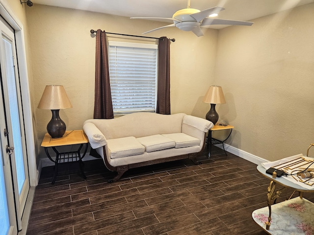 living room with a ceiling fan, wood tiled floor, and baseboards