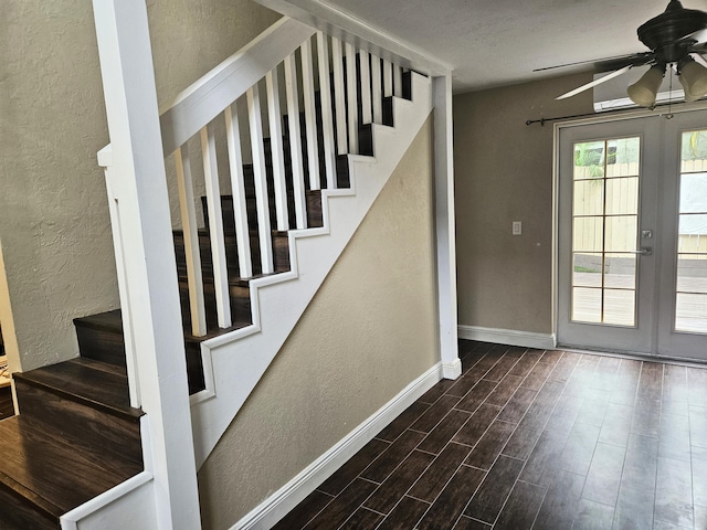 interior space featuring french doors, a textured wall, a ceiling fan, wood finished floors, and stairs