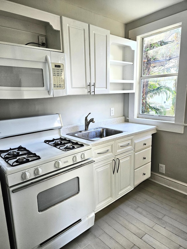 206 Edgewood Dr, West Palm Beach, FL 33405 - kitchen with white appliances, open shelves, a sink, light countertops, and light wood-type flooring
