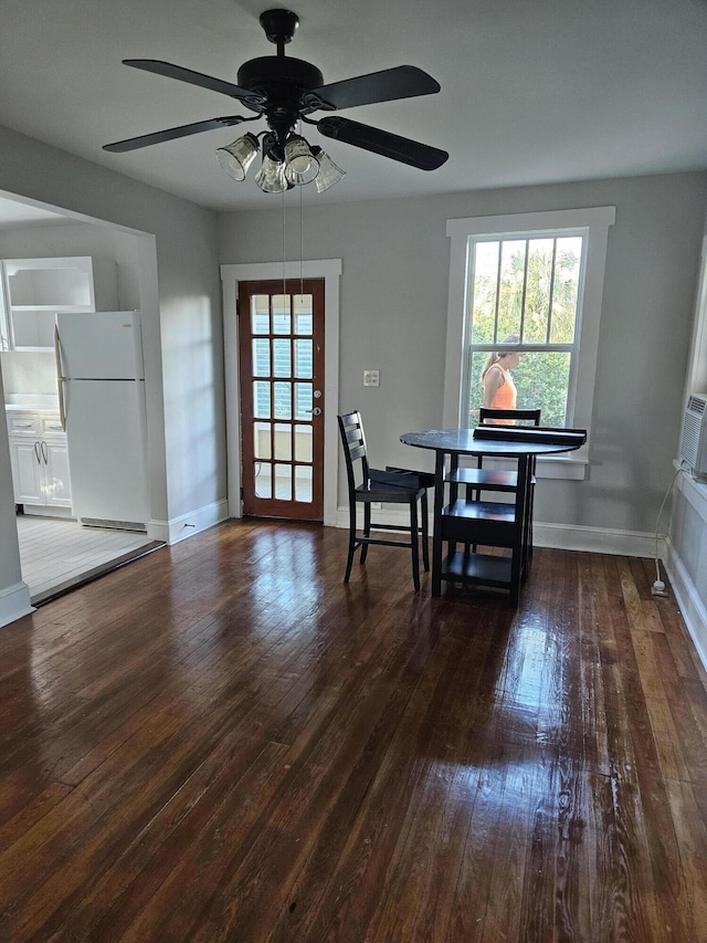 dining room with baseboards, a healthy amount of sunlight, and hardwood / wood-style floors