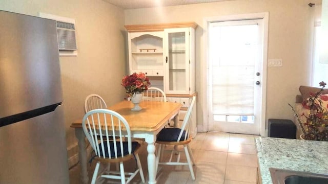 206 Edgewood Dr, West Palm Beach, FL 33405 - dining space with light tile patterned floors and a wall mounted air conditioner