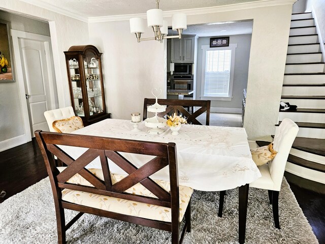 206 Edgewood Dr, West Palm Beach, FL 33405 - dining area with stairway, baseboards, an inviting chandelier, dark wood-style flooring, and ornamental molding