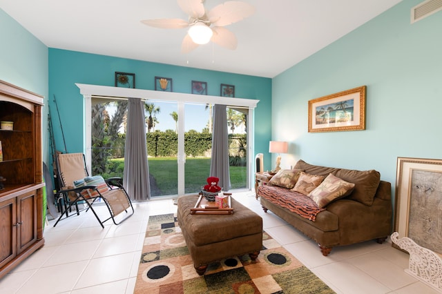 living area with a ceiling fan, visible vents, and light tile patterned flooring