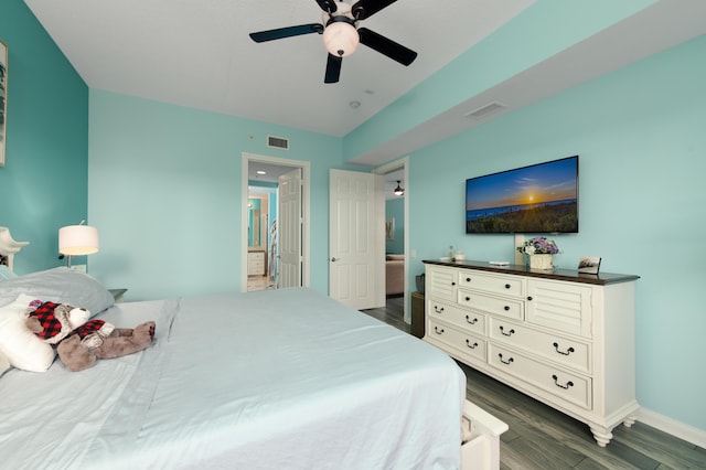 bedroom with dark wood-style floors, baseboards, visible vents, and a ceiling fan