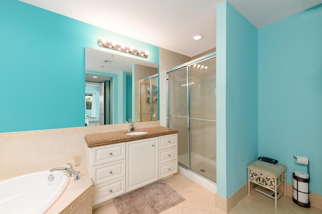 full bathroom featuring a stall shower, baseboards, tile patterned flooring, vanity, and a bath