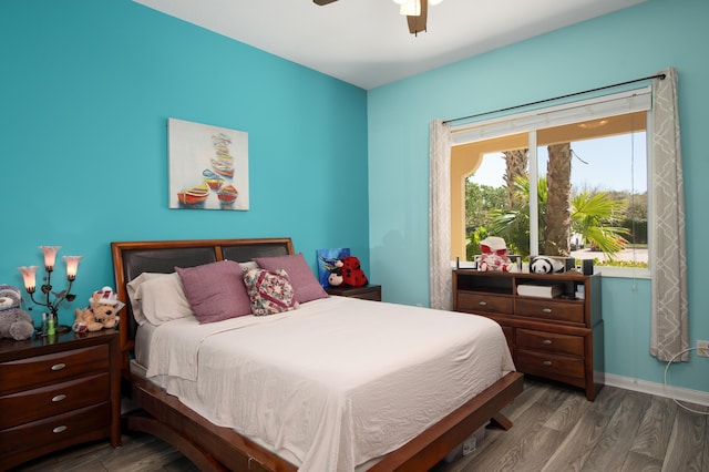 bedroom featuring dark wood-style floors, ceiling fan, and baseboards