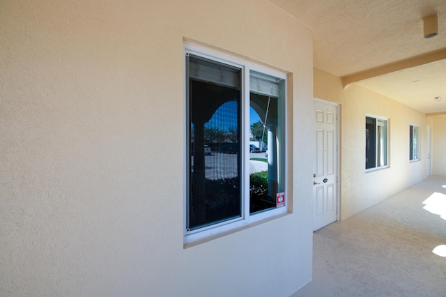 exterior space with a patio area and stucco siding