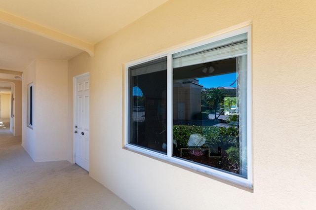 property entrance with a patio and stucco siding