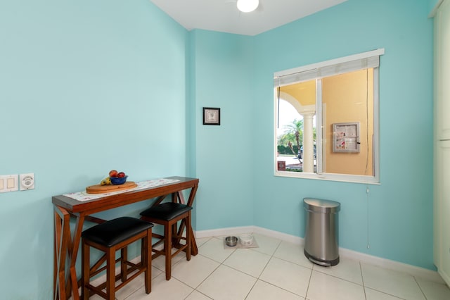 dining area with light tile patterned floors and baseboards