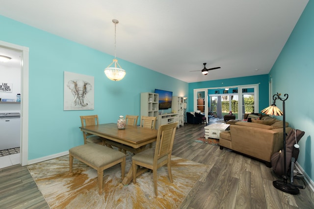 dining area with wood finished floors, a ceiling fan, and baseboards