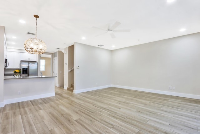 unfurnished living room with a ceiling fan, light wood-type flooring, baseboards, and recessed lighting