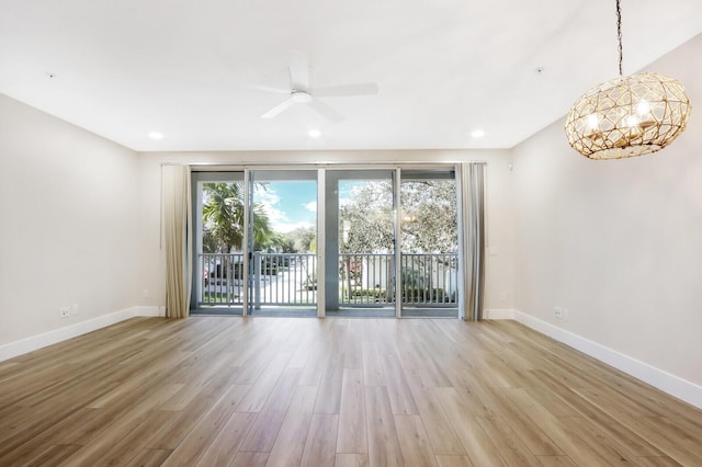 unfurnished room with baseboards, a healthy amount of sunlight, and light wood finished floors