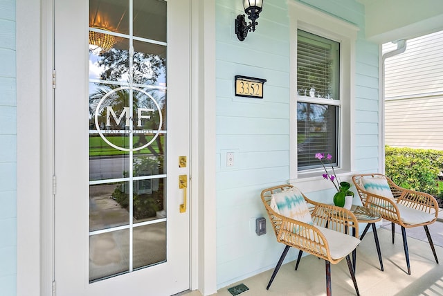 view of exterior entry featuring covered porch