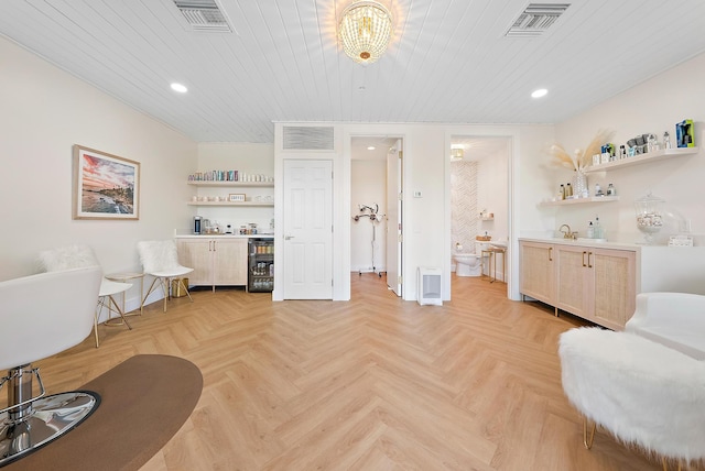 sitting room featuring a bar, wine cooler, and visible vents