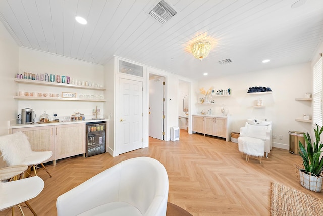 living area with a dry bar, wine cooler, visible vents, and recessed lighting