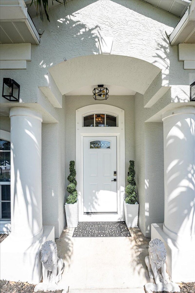 entrance to property featuring stucco siding