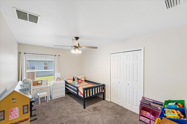 bedroom with carpet, visible vents, ceiling fan, and a closet