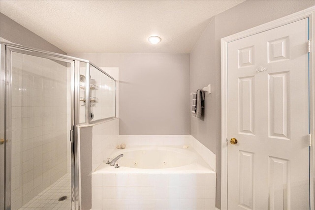 full bathroom with a jetted tub, a shower stall, and a textured ceiling