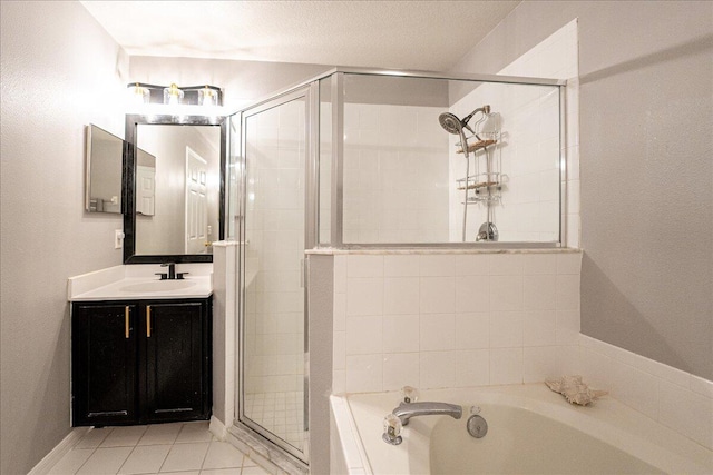 full bath featuring a garden tub, a shower stall, vanity, a textured ceiling, and tile patterned flooring