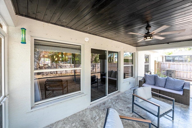 sunroom / solarium featuring wood ceiling and ceiling fan