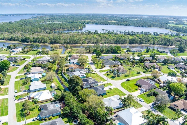 aerial view with a water view, a residential view, and a wooded view