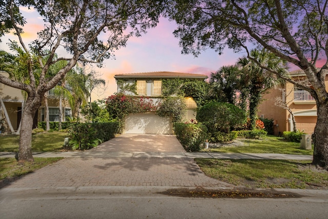 9832 Stover Way, Wellington, FL 33414 - view of front of house featuring a front yard, a tiled roof, decorative driveway, and a garage