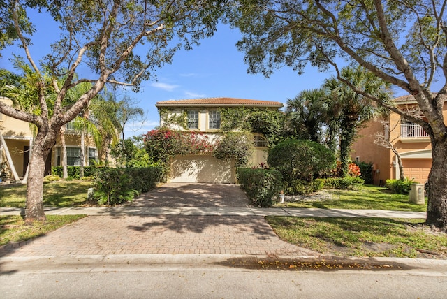 9832 Stover Way, Wellington, FL 33414 - view of front of house with a tiled roof, decorative driveway, stucco siding, and a garage
