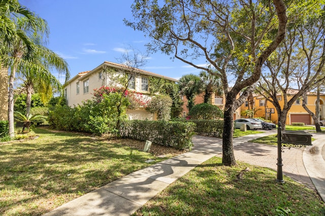 9832 Stover Way, Wellington, FL 33414 - exterior space featuring stucco siding, a front lawn, and a residential view